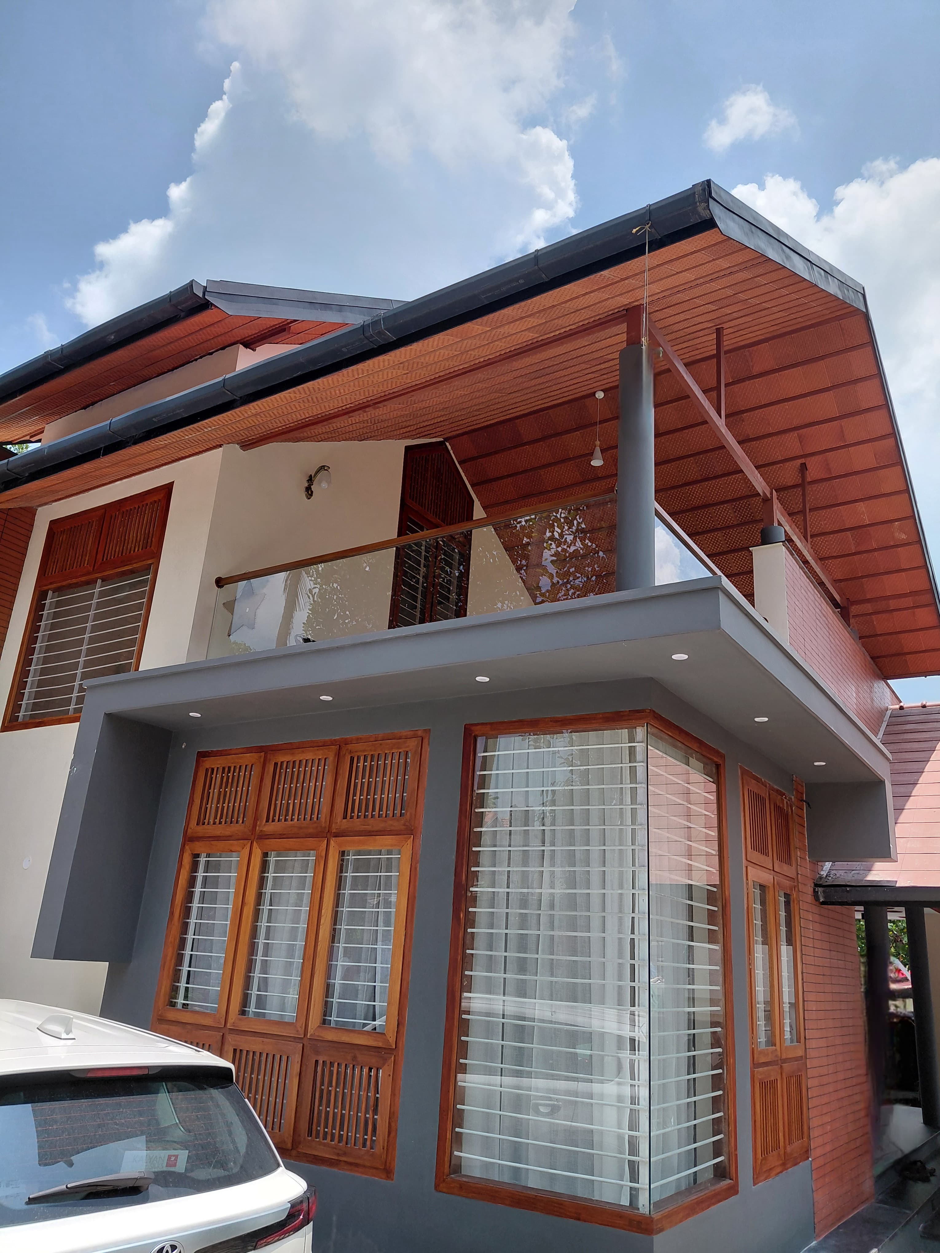 Stainless steel balcony with wooden handrail