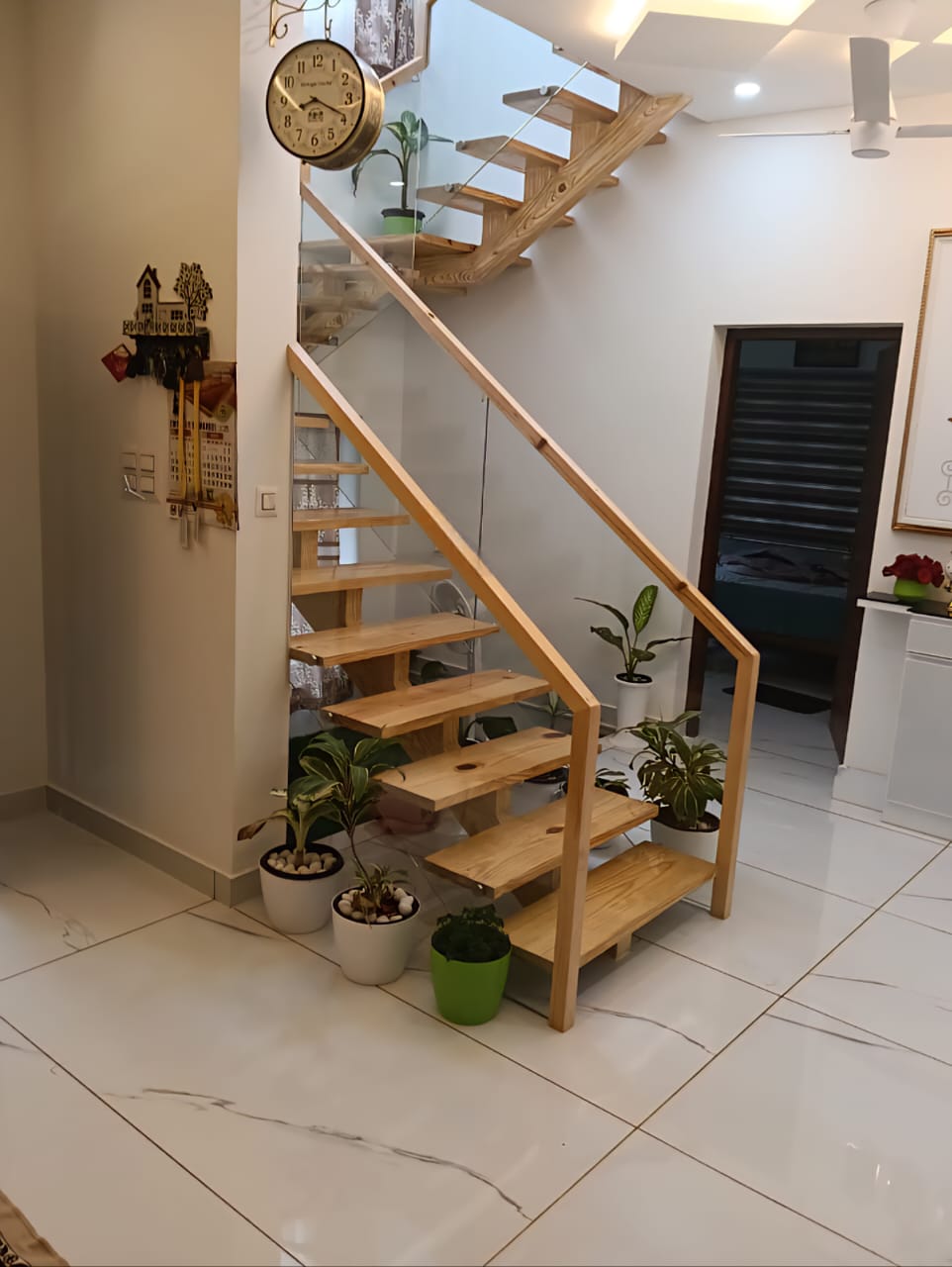 Staircase with glass panels and wooden handrail